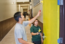 Rotaract club members painting door